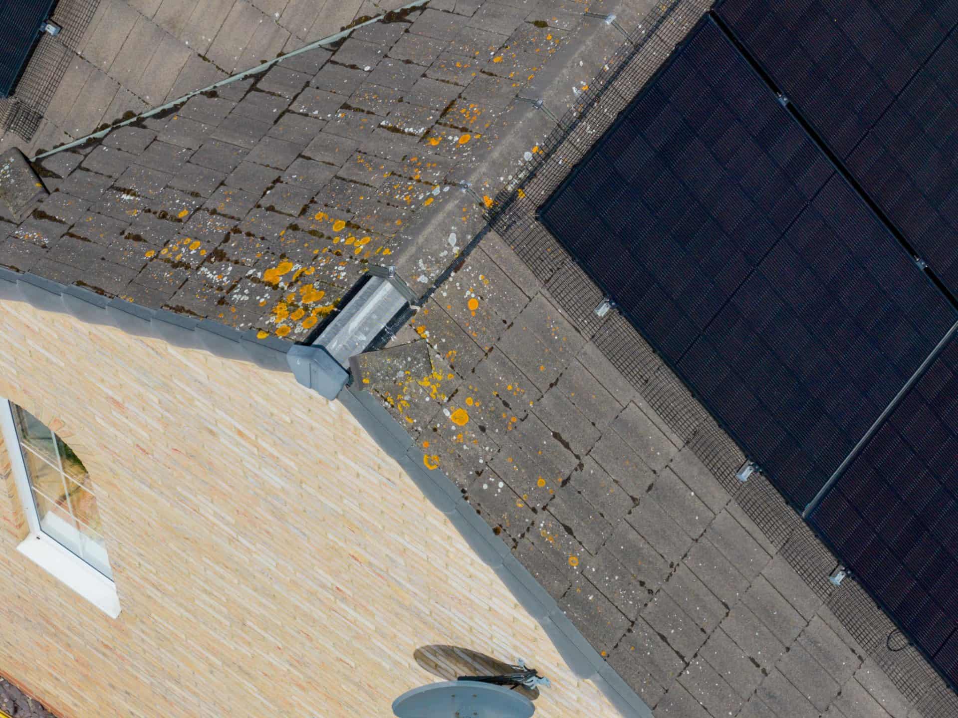 Close aerial view of rooftop solar panel installation on a modern residential property in Wakefield West Yorkshire showing renewable energy technology roof maintenance issues and a broken roof tile